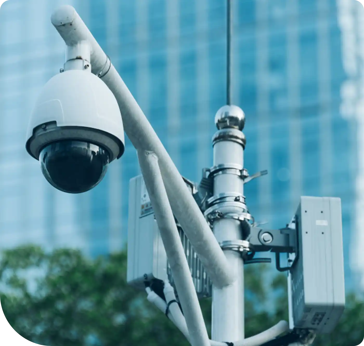 Detailed view of a surveillance camera system on a pole with a building in the background